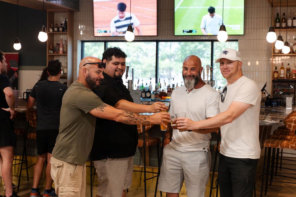 Guests toasting at the At Fault bar